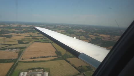 Look-out-the-window-of-a-small-private-jet-flying-over-fields
