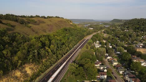 Bluffs-next-to-a-road-in-Red-wing-Minnesota-during-summer-time-aerial-footage