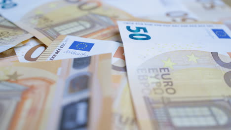 Close-up-of-details-on-50-euro-paper-money-bills---static,-focus-pull-view