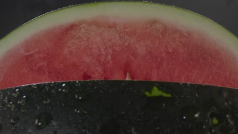 A-backwards-dolly-movement-revealing-a-fresh-watermelon,-from-the-red-soft-flesh-inside-to-the-hard-green-peel-outside