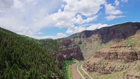 Aerial-Footage-Of-Beautiful-Canyon-Gorge-With-River-At-The-Bottom-Near-Alpine-Forest-During-Bright-Summer-Day
