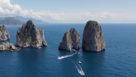 Famous-Italy-Landmark-of-Faraglioni-Sea-Stack-Rocks-on-Island-of-Capri,-Aerial