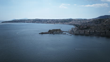Slow-aerial-hyperlapse-rotation-around-Castel-dell'Ovo-in-Naples,-Italy