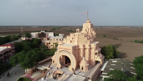 Aerial-rotating-shot-of-Palitana-temple-with-empty-field-in-the-background