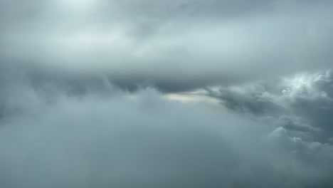 Awesome-aerial-pilot-point-of-view-flying-through-a-turbulent-and-stormy-sky-looking-for-a-gap-through-the-clouds-to-avoid-problems