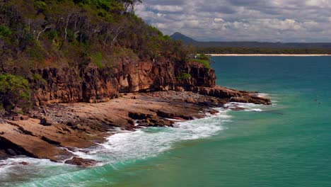 Rough-Waves-On-Noosa-National-Park-With-People-Floating-With-Surfboards-In-QLD,-Australia