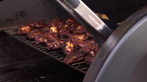 Narrow-focus:-Golden-brown-chicken-wings-are-flipped-on-BBQ-grill