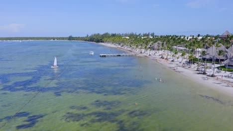 Drone-flying-over-Bavaro-beach-and-jetty,-Punta-Cana-in-Dominican-Republic