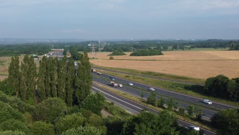 Aerial-view-countryside-agricultural-rural-farmland-in-Rainhill-and-busy-M62-motorway-traffic