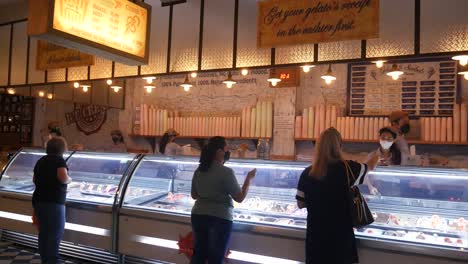 Yogyakarta,-Indonesia---June-17,-2022-:-Waiter-serving-People-who-buying-ice-cream-inside-Tempo-Gelato-outlet-in-Yogyakarta,-Indonesia