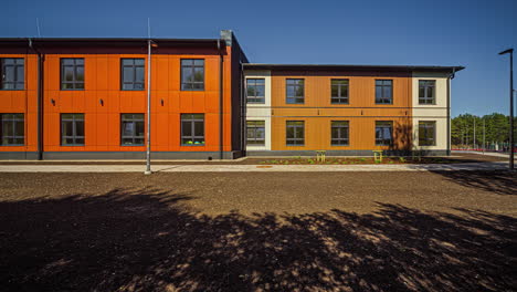 Exterior-Of-School-Made-Of-Wood-Container-House-With-Orange-Facade