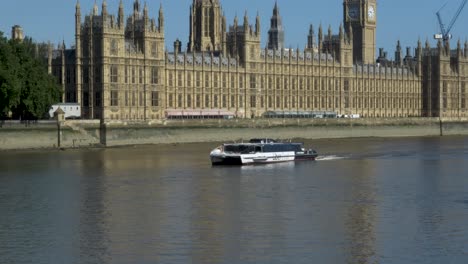 Uber-River-Boat-Going-Past-Houses-Of-Parliament-On-14-June-2022-Viewed-From-Albert-embankment-path