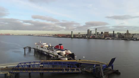 Stena-Line-logistics-cargo-ship-terminal-aerial-pull-back-low-across-Birkenhead-Liverpool-harbour-city-landscape