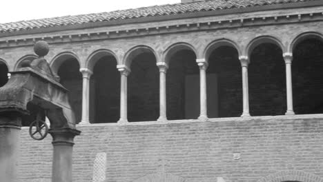 Black-And-White-Panorama-Of-Portico-Of-The-Basilica-Of-Santo-Stefano-In-Bologna,-Italy
