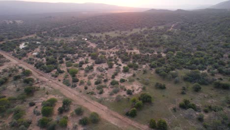 dirt-road-crosses-through-remote-landscape-in-african-savannah