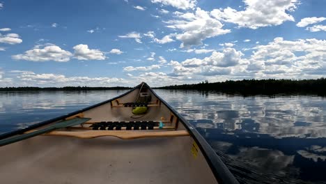 Crossing-calm-lake-in-Canadian-canoe-relaxing-perspective