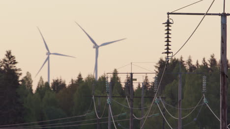 DAWN,-GOLDEN-HOUR---Wind-turbines-spin-behind-electricity-cables