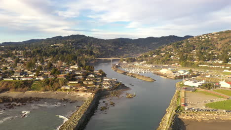 Port-of-Brookings,-Oregon.-Drone-backwards-over-jetty