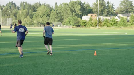 Mature-men-running-and-jogging-on-a-soccer-field