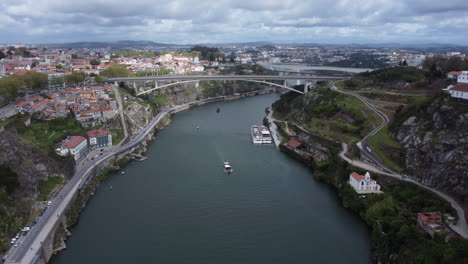 Boat-sailing-on-Douro-River,-Porto,-Portugal