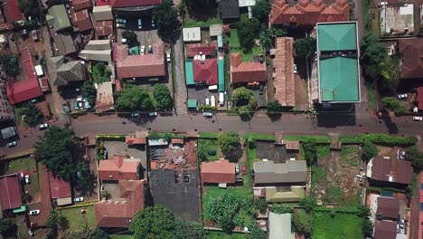 Drone-look-down-to-a-street,-road-and-housing-area-in-Kampala-city,-Uganda