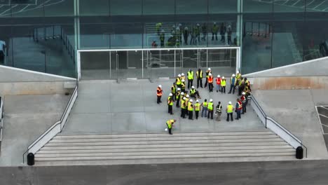 Bauarbeiter-In-Leuchtend-Gelben-Westen-Treffen-Sich-Als-Team,-Um-Das-Projektmanagement-Zu-Besprechen