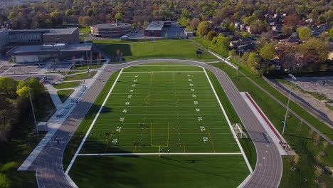 High-school-track-with-football-and-soccer-field-surrounded-by-neighborhood-homes