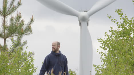 WIND-TURBINES---A-man-in-his-40s-removes-his-hat-having-a-break-from-the-walk