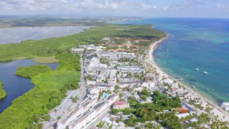 Stunning-aerial-view-of-luxury-beachside-resorts-and-Laguna-Bavaro,-Punta-Cana