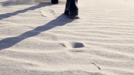 Ultra-slow-motion-close-up-shot-of-boots-walking-on-sand-in-Death-Valley-National-Park-in-California,-USA