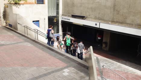 People-coming-and-going-at-the-entrance-and-exit-of-the-subway-station-in-the-Japanese-neighbourhood-of-Liberdade-in-São-Paulo,-Brazil