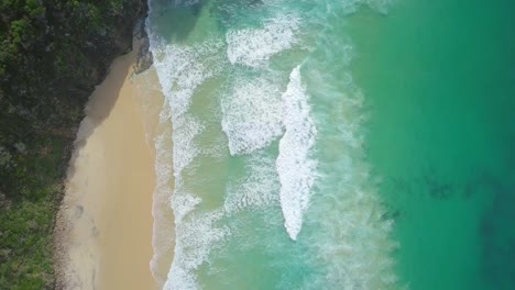 Stunning-aerial-flight-over-strong-waves-and-isolated-lonely-beach,-Australia