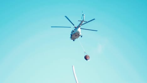 Helicopter-flying-away-after-dropping-water-on-fire