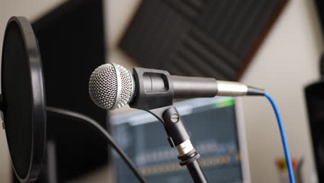 A-vocal-microphone-and-pop-filter-for-singing-or-recording-a-podcast-in-a-bedroom-music-studio-SLIDE-LEFT