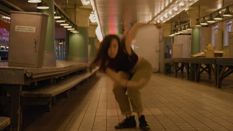 Young,-female,-contemporary-dancer-in-urban-market-after-hours