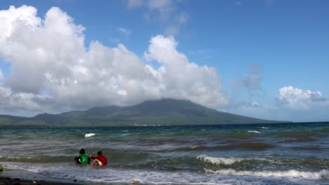 Kids-Playing-at-the-Beach-with-a-Beautiful-Mountain-in-the-Background