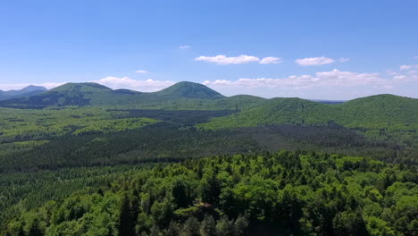 Drone-Pull-Back-and-Reveal-Shot-of-Volvic-Volcano-and-Forest-in-France