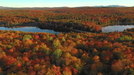 Aerial-Footage-Orbiting-around-causeway-between-two-ponds-with-full-autumn-colors