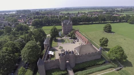 A-drone-shot,-with-the-drone-panning-down,-capturing-a-castle-in-The-Netherlands