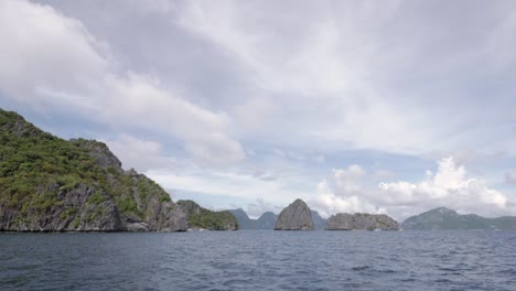 Sailing-towards-limestone-cliffs-and-islands-in-El-Nido,-Palawan,-the-Philippines-in-ultra-slow-motion