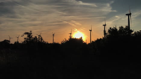 Panning-shot-of-wind-turbines-during-golden-sunset