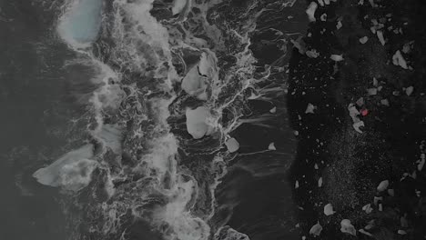 Aerial-Shot-Directly-Above-Waves-Crashing-on-an-Iceberg-Beach