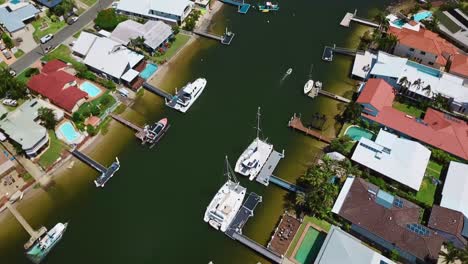 Aerial-view-of-coastal-town-district-with-houses-by-the-canal-for-boats