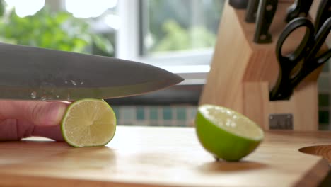 Slow-motion-shot-of-a-lime-being-sliced