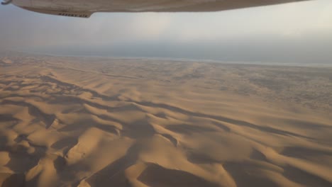 Wide-Epic-shot-of-the-Skeleton-Coast,-Namibia,-shot-froma-Small-Airplane-with-Some-Turbulence-and-Clouds