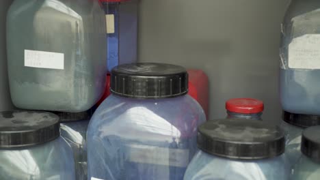 Plastic-containers-full-of-blue-pigment-color-in-laboratory
