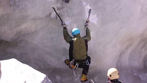 Falling-down-of-a-mountaineer-while-climbing-ice-mountain-in-upper-Himalayas,-Uttarakhand-India-with-full-safety---protection