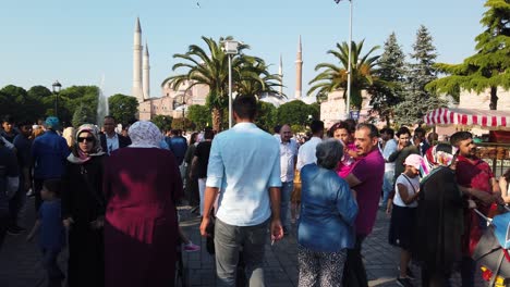 Unidentfied-people-walk-at-Sultanahmet-Park-where-Blue-Mosque-or-Sultan-Ahmet-Mosque-and-Hagia-Sophia-located-in-Istanbul,-Turkey