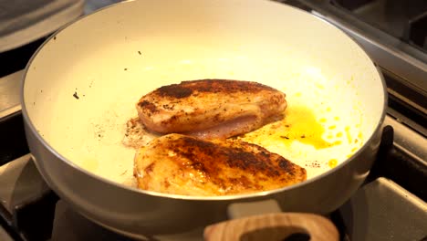 Chicken-being-fried-in-a-pan-on-a-gas-stove-4K