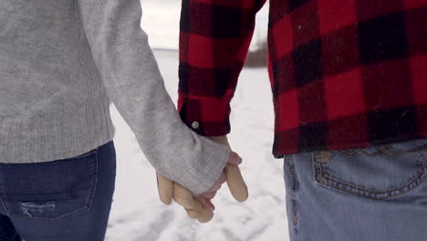 Slow-motion-close-up-of-couple-ice-skating-hand-in-hand